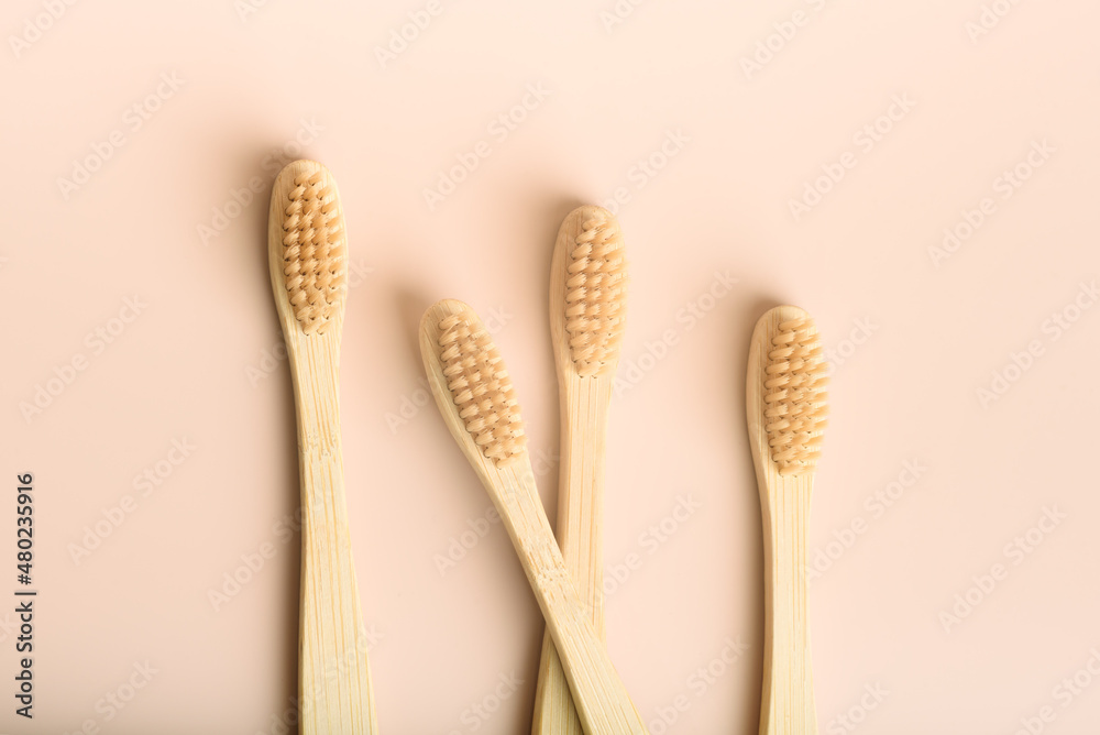 Four with three eco friendly natural bamboo toothbrushes on pink background. Health care, copy space. Zero waste concept. Four with three eco friendly natural bamboo toothbrushes on pink background. Health care, copy space. Zero waste concept.