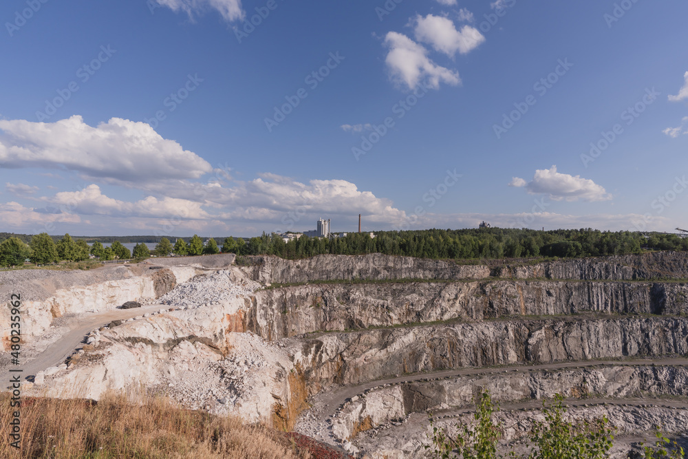 Fototapeta premium Dolomite quarry Photo from above. Industrial terraces in a quarry. Aerial view of open pit mining. Excavations of the Dolomite mine. Mining industry.