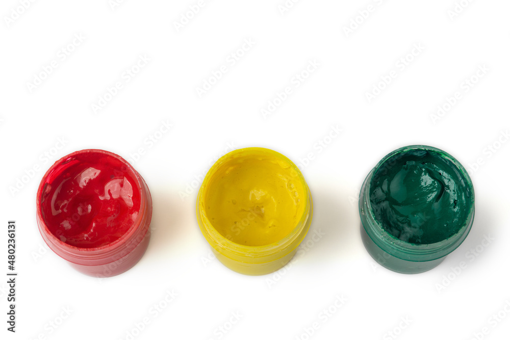 Jars of red, yellow and green gouache on a white isolated background. Traffic light concept, children's creativity. Bright colours. Jars of red, yellow and green gouache on a white isolated background. Traffic light concept, children's creativity. Bright colours.