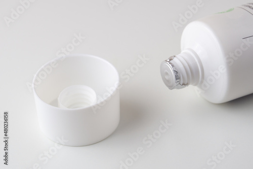 Canvas Print Sealed white tube of ointment and cap on a white background