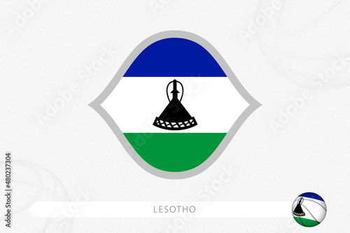 Lesotho flag for basketball competition on gray basketball background.