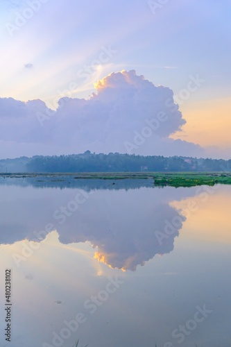lake in the morning with symmetrical reflection of clouds