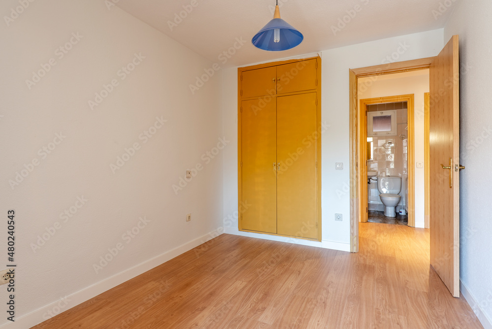 Room next to the toilet with built-in wardrobe and birch wood carpentry Room next to the toilet with built-in wardrobe and birch wood carpentry