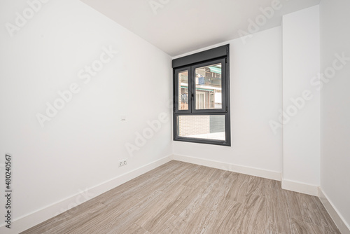 Empty room with black aluminum window  white walls and porcelain stoneware floors