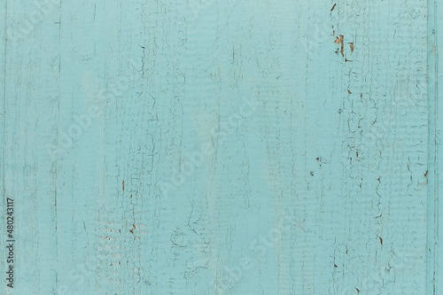 Old shabby wooden planks with cracked color paint, background. light blue