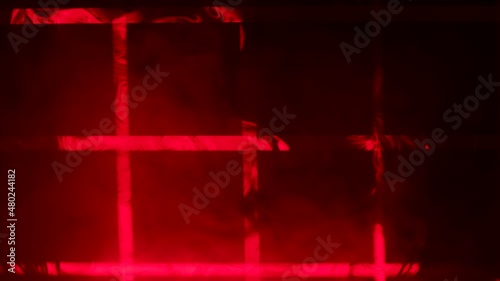 Red laser beams from stage lights create a checkered pattern in a dark studio with thick clouds of smoke. Lighting equipment. Lighting effects. Show of stage holograms. Close up. Slow motion. photo