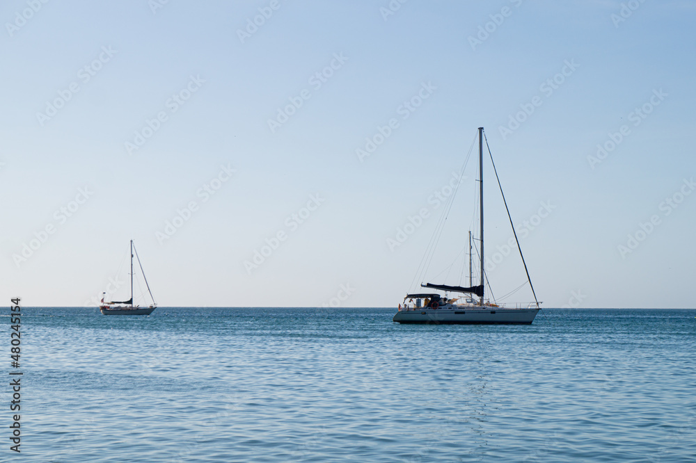 A couple of sailboats on the horizon of the sea