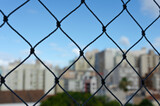 skyline view with blue sky from a window with security net