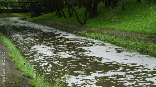 Water pollution. Pollution of a channel caused by surfactants. White foam in a stream kills life.