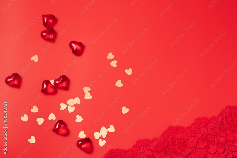 Red Valentine's Day background with beautiful female lacy panties and hearts. Sexy underwear. Free space for text, copy space. Postcard, greeting card design. Love, celebration concept.