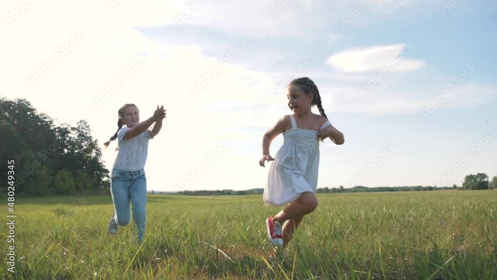 Cheerful, happy children are resting and playing in the park on summer holidays. Happy childhood of children in nature. Fresh healthy park for children in summer. Children play jogging in the park. Cheerful, happy children are resting and playing in the park on summer holidays. Happy childhood of children in nature. Fresh healthy park for children in summer. Children play jogging in the park.
