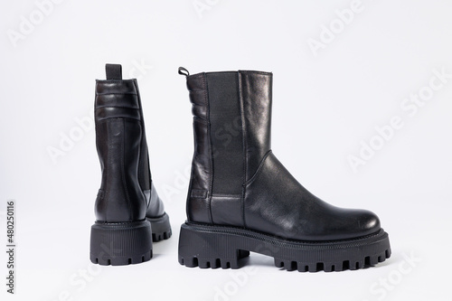 Women's shoes on a white background. Close-up of women's black leather chelsea boots on a white background. Shoes for the city. Fashion, design and footwear concept.