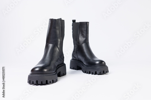 Women's shoes on a white background. Close-up of women's black leather chelsea boots on a white background. Shoes for the city. Fashion, design and footwear concept.