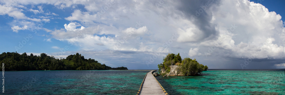 Bridge from Bajo village, Bridge over the ocean connecting island with another island, big pier, on clean turquoise waters on panorama photo, Sulawesi, Indonesia