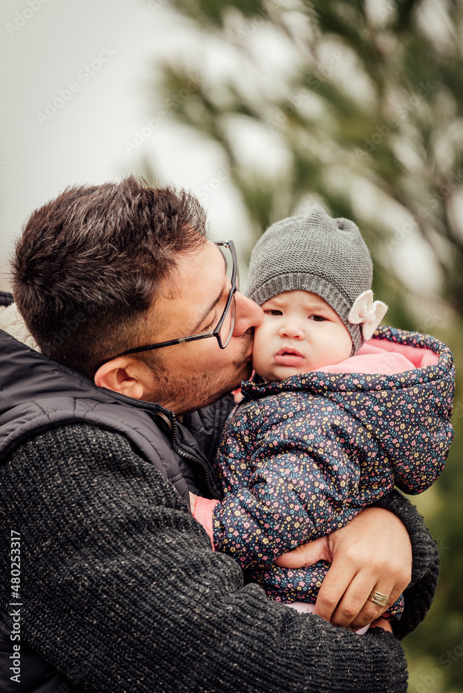 Fototapeta premium Father playing with his daughter outside in the park