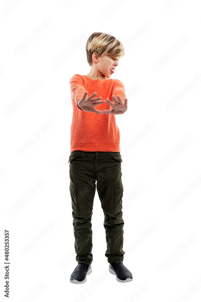 The boy stands with his arms outstretched, palms forward. A guy in dark jeans and an orange sweater. Sign no, disgust and rejection. Isolated on white background. Vertical. The boy stands with his arms outstretched, palms forward. A guy in dark jeans and an orange sweater. Sign no, disgust and rejection. Isolated on white background. Vertical.