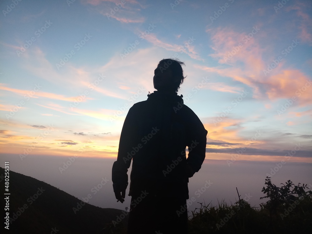 silhouette of man standing on top of mountain INDONESIA