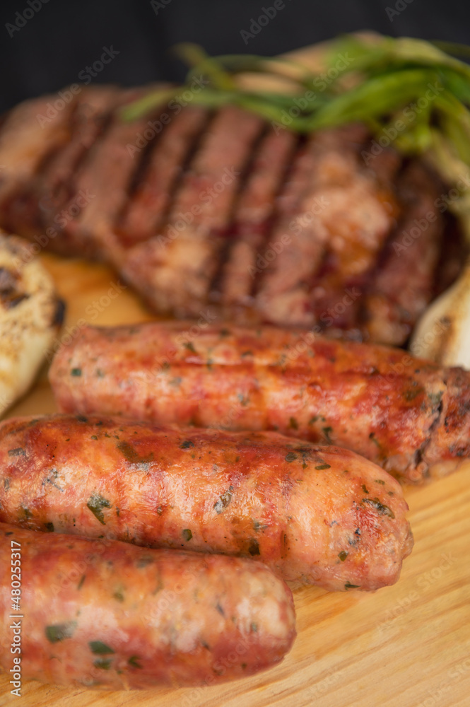 Grilled with rib of beef, chistorra and sausages. Golden sausages ready for the celebration of the picnic. Charcoal grill concept. Amatlan, Mexico