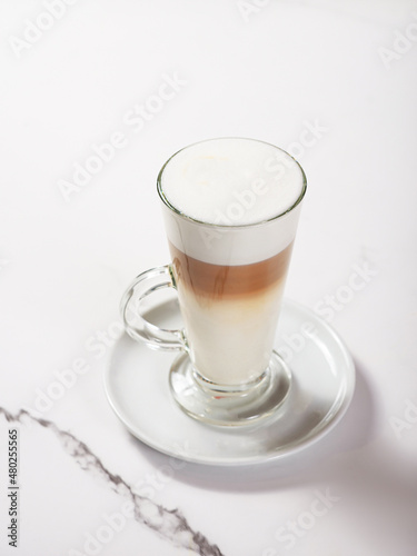 Latte in a glass mug on a white background