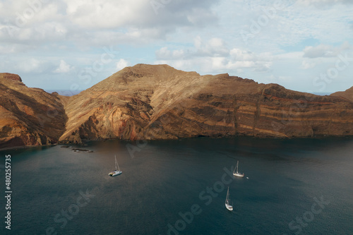 Sao Lorenco Peninsula, Madeira, Portugal. Rocky ocean coast and three boats.  photo