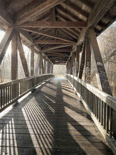 wooden bridge with strong lines and graffiti