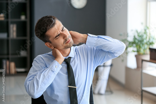 Businessman feeling neck pa...