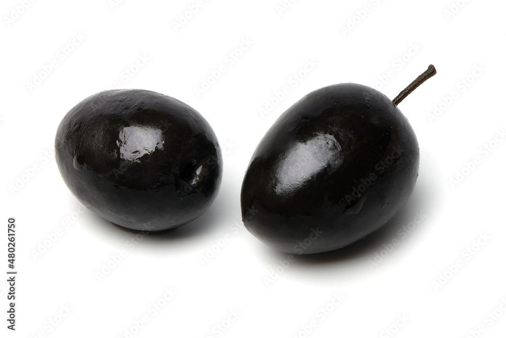 Black olives isolated on white background. Two black olives with pit. Clipping Path. Black olives isolated on white background. Two black olives with pit. Clipping Path.