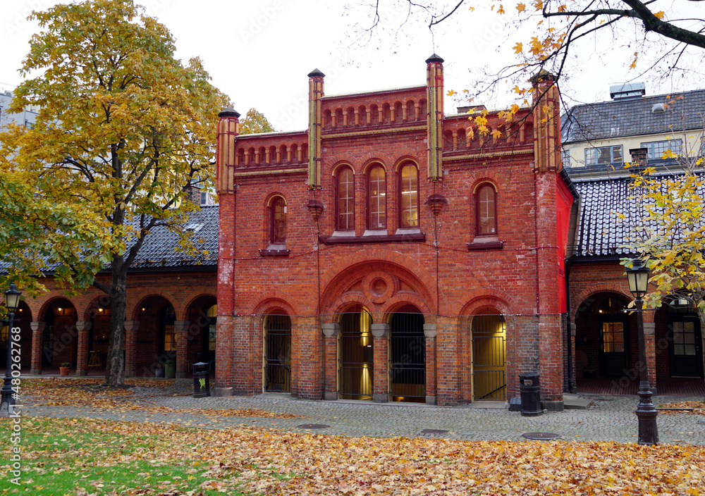 Obraz premium Facade of a building with a red facade that is being restored