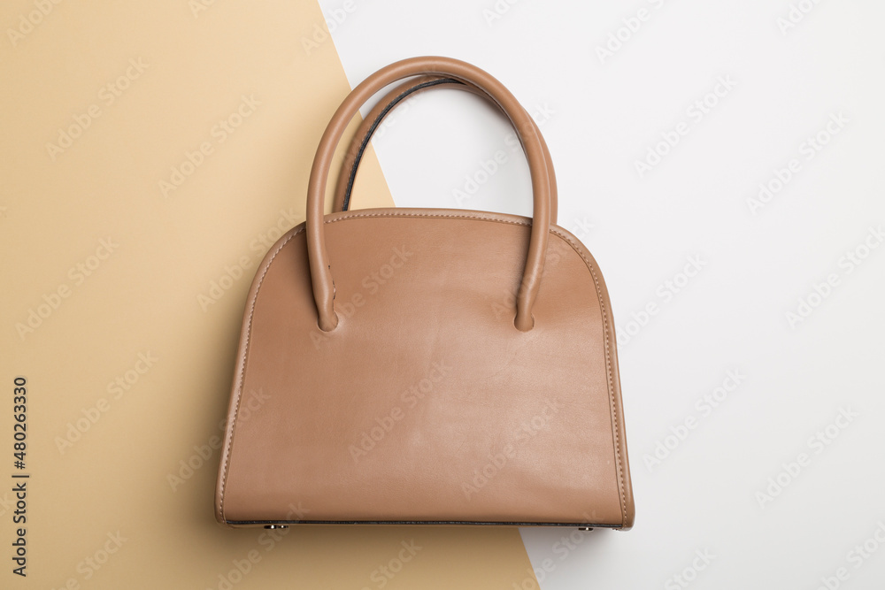 Fashionable woman bag on color background. Top view Fashionable woman bag on color background. Top view