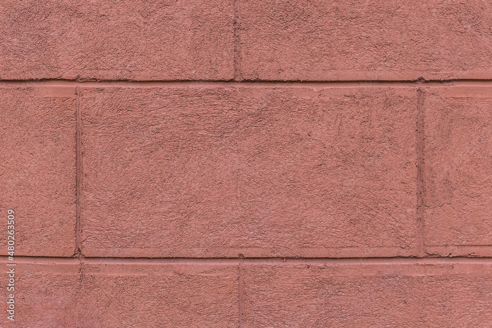 Fototapeta premium Part of the facade of the house with painted wall of brick blocks with brown paint exterior architecture background