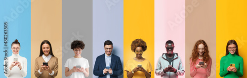 Group of smiling diverse people texting with phones, isolated on multicolored background