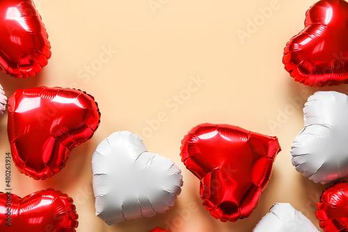 Heart-shaped air balloons for Valentine's day on beige background