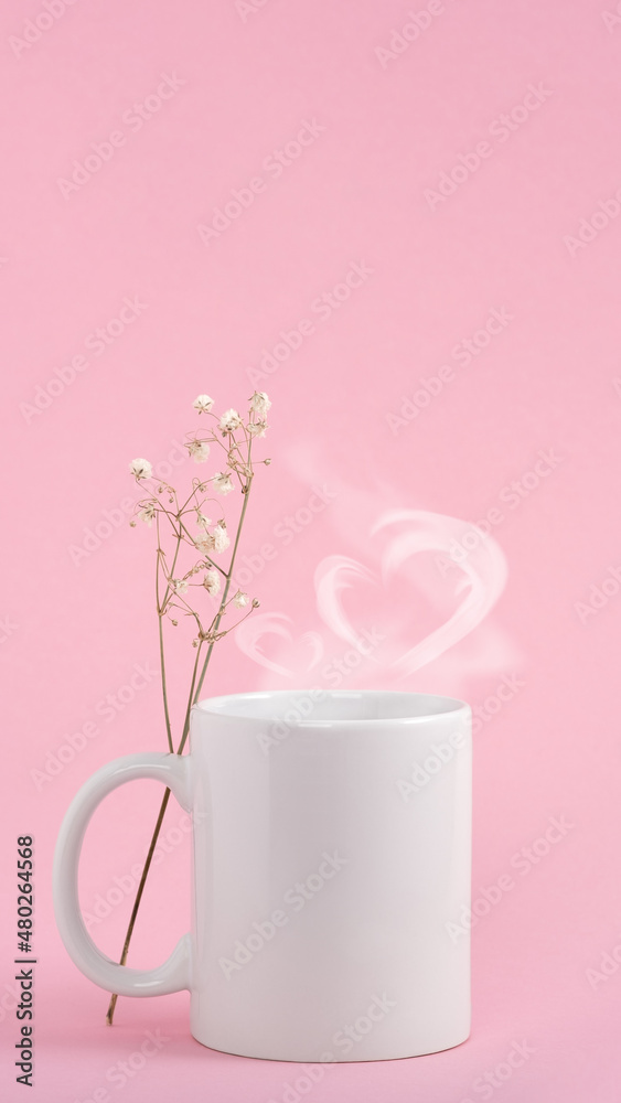 Mockup white coffe cup or mug on a pink background. Hot drink steam in the form of heart Mockup white coffe cup or mug on a pink background. Hot drink steam in the form of heart