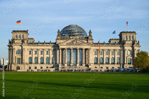 Berlin, building of German Parliament. National flags flying on a flagpole in a front of Reichstag building in Berlin, Germany. German Bundestag.