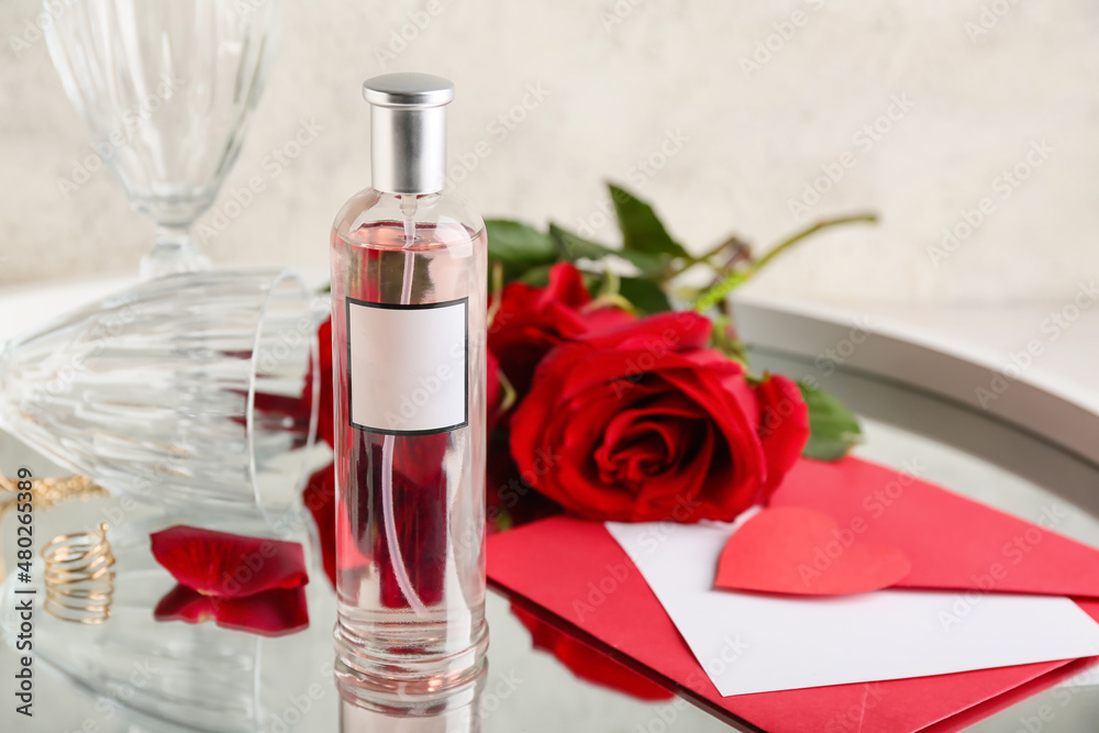Perfume, envelope and roses for Valentine's day on table, closeup Perfume, envelope and roses for Valentine's day on table, closeup