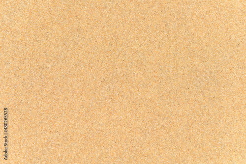 Texture of beach sand grains up close.