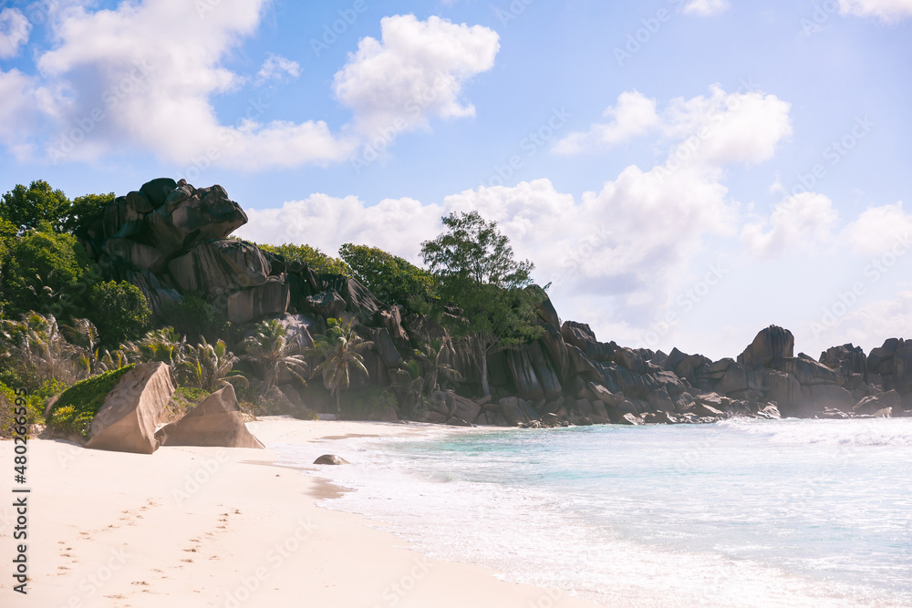 The famous Source d'Argent beach on La Digue island, Seychelles, with beautiful palm trees and large stones