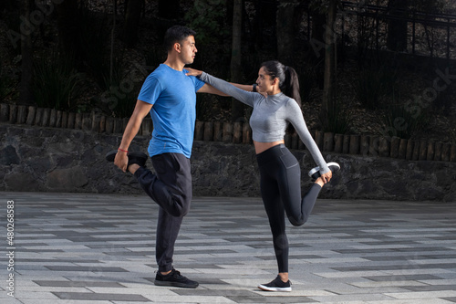 young mexican athletic couple exercising in the park