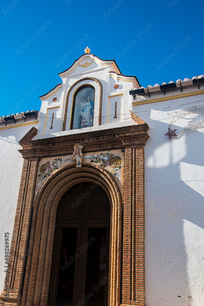 Fototapeta premium Competa is self sufficient and thriving Town with a municipal market. It has a charming flower bedecked old town with its main square, the Plaza Almijara,dominated by a magnificent 16th century church