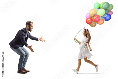 Full length profile shot of a girl with balloons running towards her father