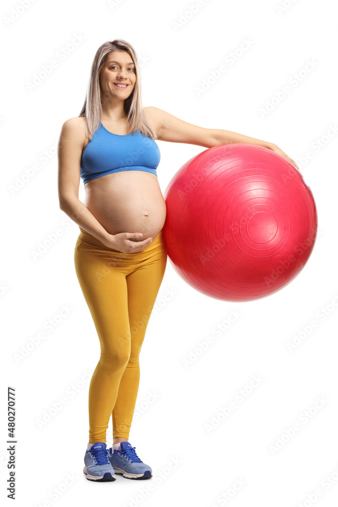 Full length portrait of a pregnant woman in sportswear holding a fitness ball Full length portrait of a pregnant woman in sportswear holding a fitness ball