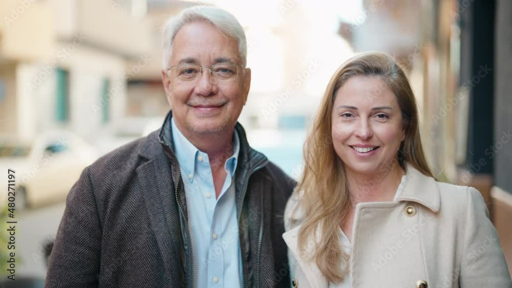Middle age couple couple smiling confident standing together at street Middle age couple couple smiling confident standing together at street