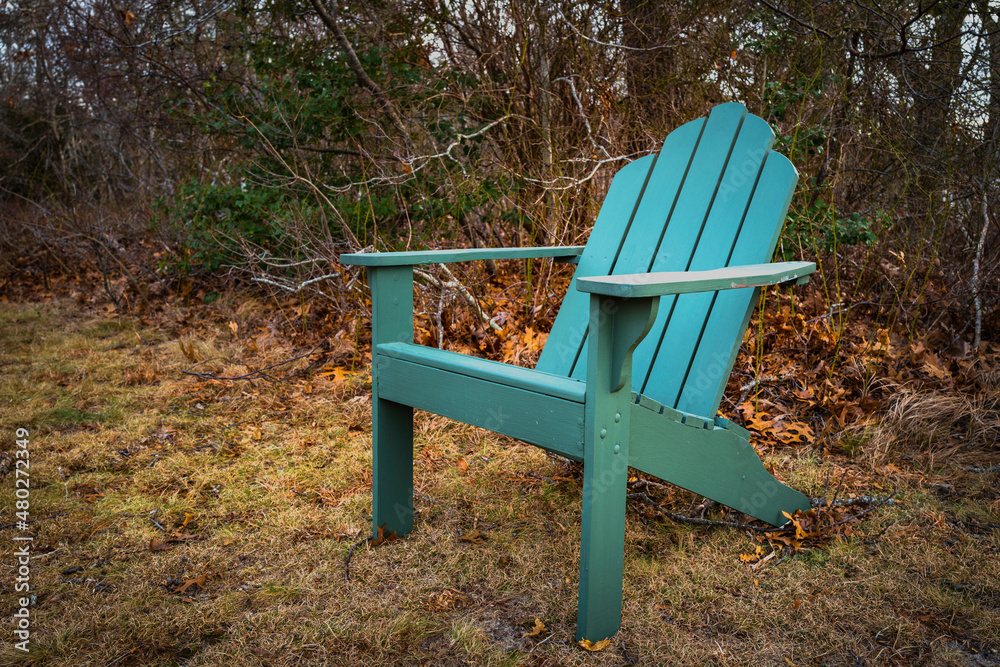 Green empty wooden bench. Cape Cod Adirondack chair in the autumn yard Green empty wooden bench. Cape Cod Adirondack chair in the autumn yard