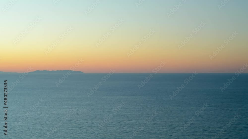 Sunset in the gulf of Baratti, Tuscany Italy with Capraia island in the background. Time lapse with moving water and clouds in winter Sunset in the gulf of Baratti, Tuscany Italy with Capraia island in the background. Time lapse with moving water and clouds in winter