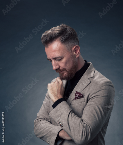 Frustrated middle aged elegant man Close up face of a stressed businessman wearing a stylish suit with eyes closed. Side shot © .shock
