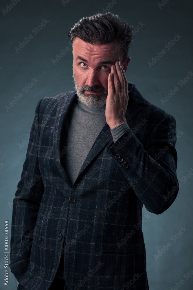 Frustrated middle aged elegant man Close up face of stressed businessman wearing stylish suit with eyes closed. Overworked middle eastern business man with terrible migrain Frustrated middle aged elegant man Close up face of stressed businessman wearing stylish suit with eyes closed. Overworked middle eastern business man with terrible migrain