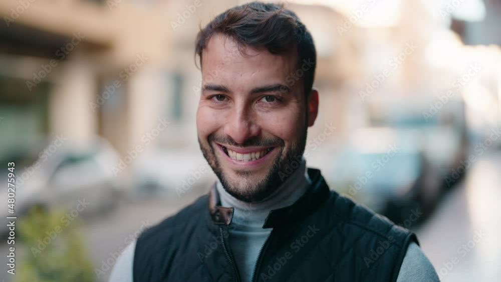 Young hispanic man smiling confident standing at street Young hispanic man smiling confident standing at street