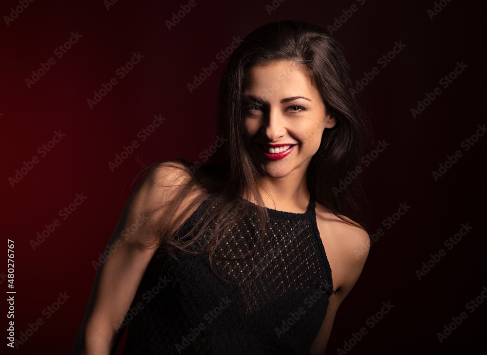 Beautiful happy laughing woman with red lipstick with bright makeup on dark red background with empty copy space. Closeup Beautiful happy laughing woman with red lipstick with bright makeup on dark red background with empty copy space. Closeup