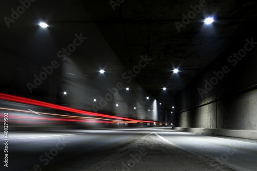 Blurry image of a dark tunnel with dim lights. © Azazello