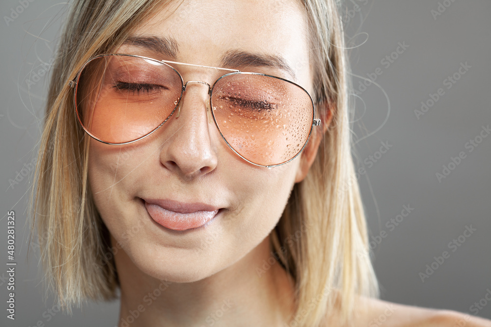 Beautiful girl fashion portrait. Wearing wet glasses with water drops visible Beautiful girl fashion portrait. Wearing wet glasses with water drops visible